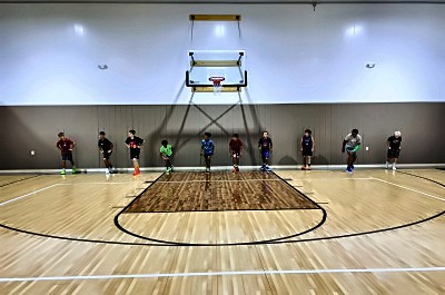Athletes lined up on the court at Legends Sports Center